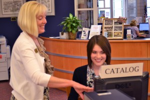 Library Director Desiree Webber interacts with library patron