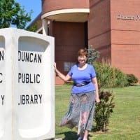 Library director Jan Cole stands in front of Duncan Public Library