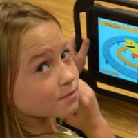 Butner student plays a learning game on a tablet