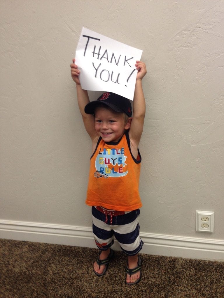 Butner student holding 'thank you' sign