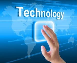 Hand touching monitor with the word "Technology"