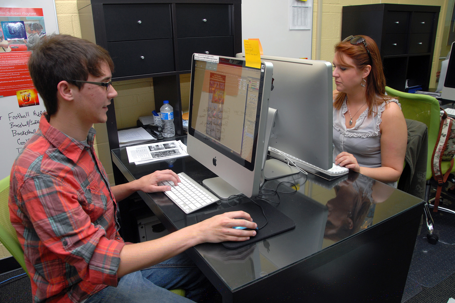 Male and female student using computers