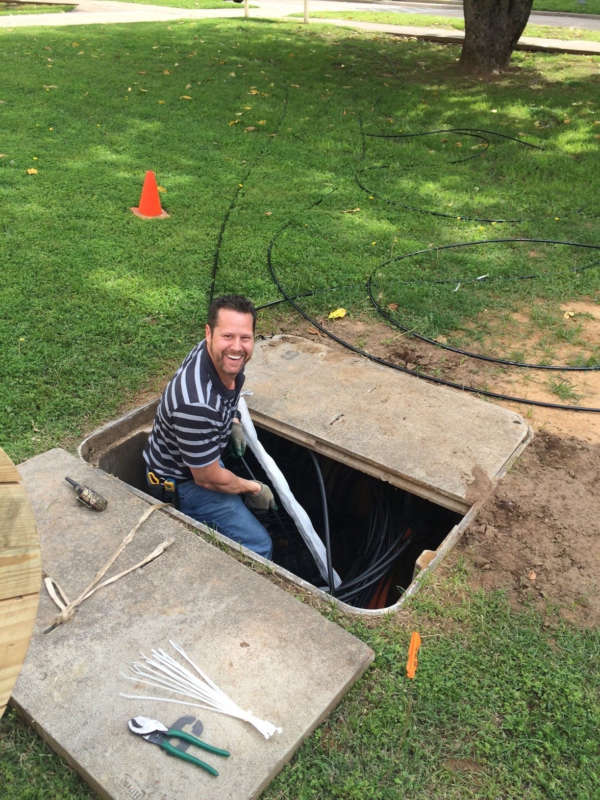 Man pulling fiber into the ground