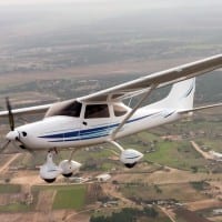 Airplane flies over rural community