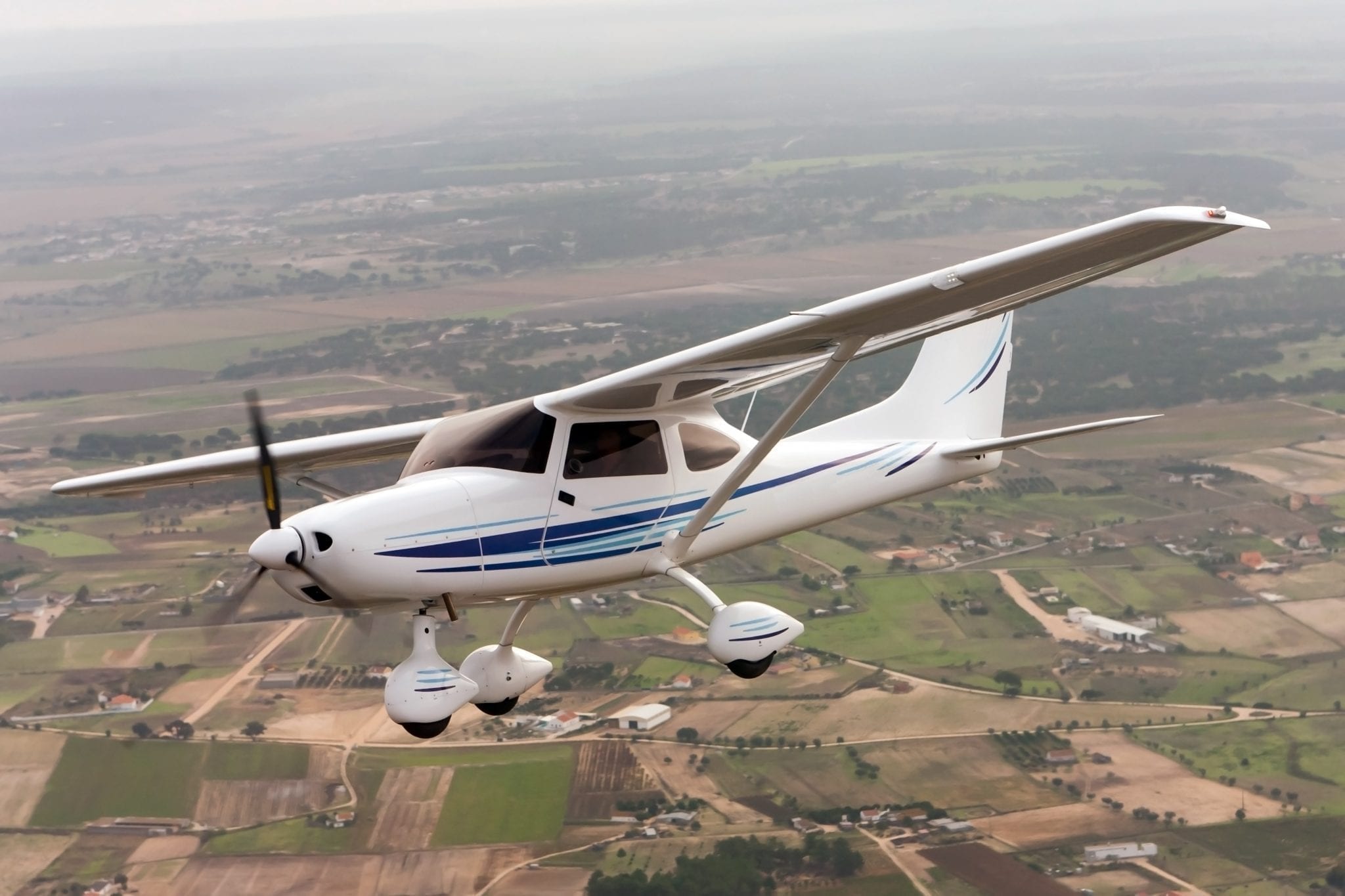 Airplane flies over rural community