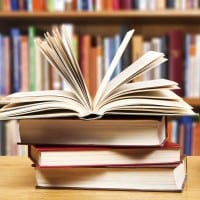 Photo of books on a table in a library