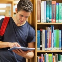 man using Ipad in a library