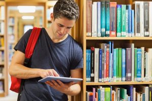 man using Ipad in a library